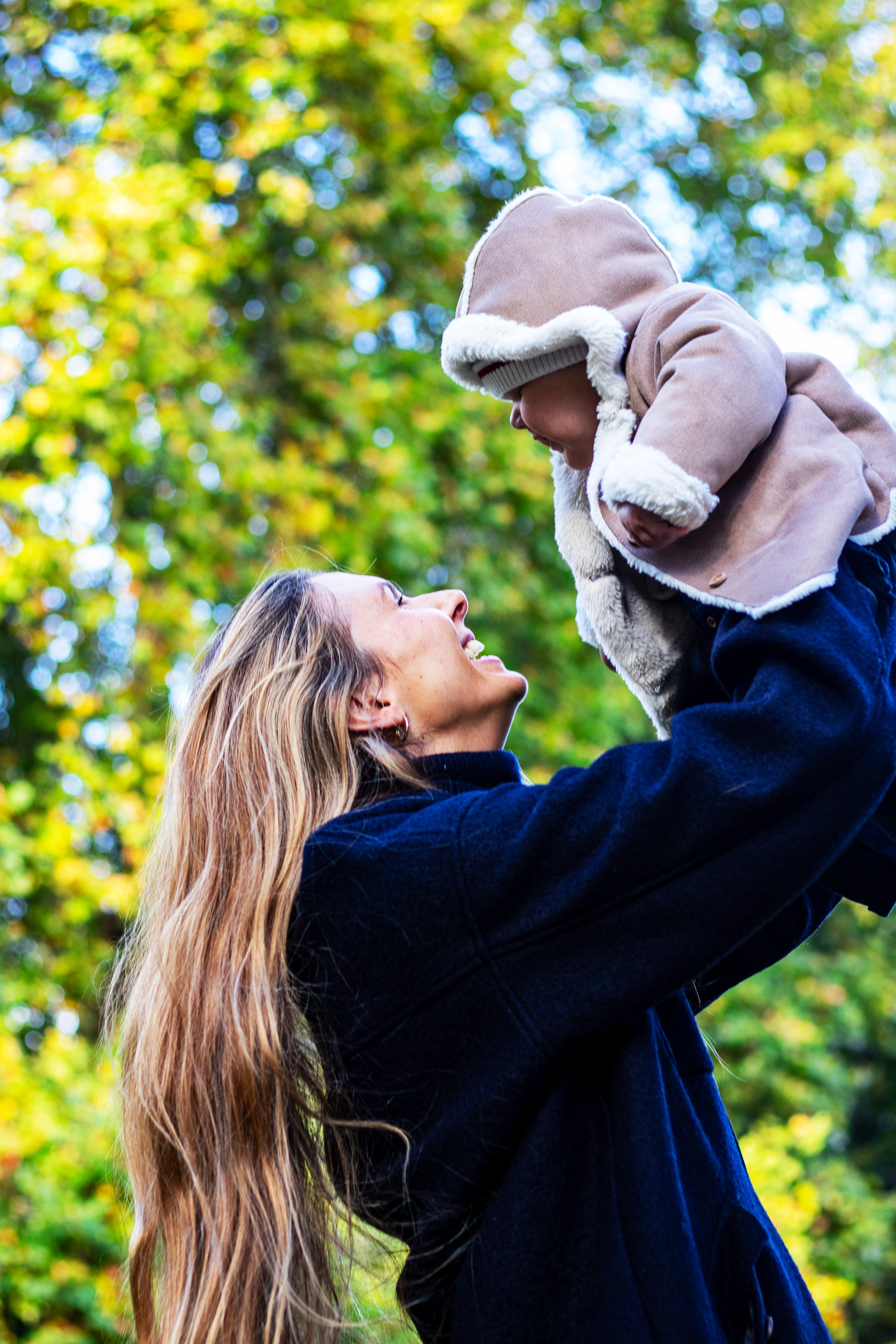 Mother and son smiling together in the park